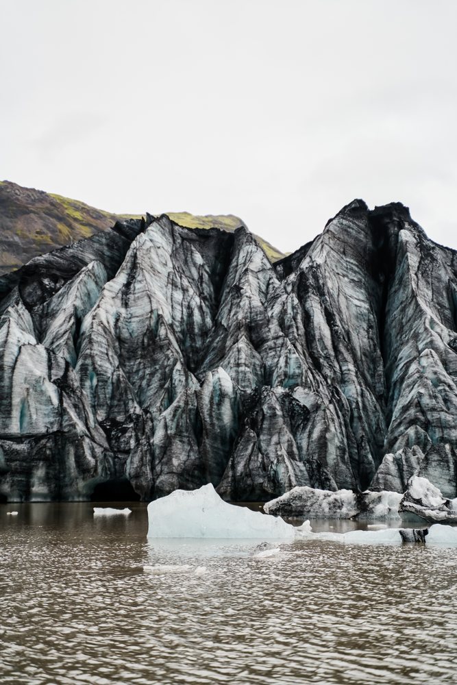 Icy glacier cliffs with floating icebergs in a glacial lagoon