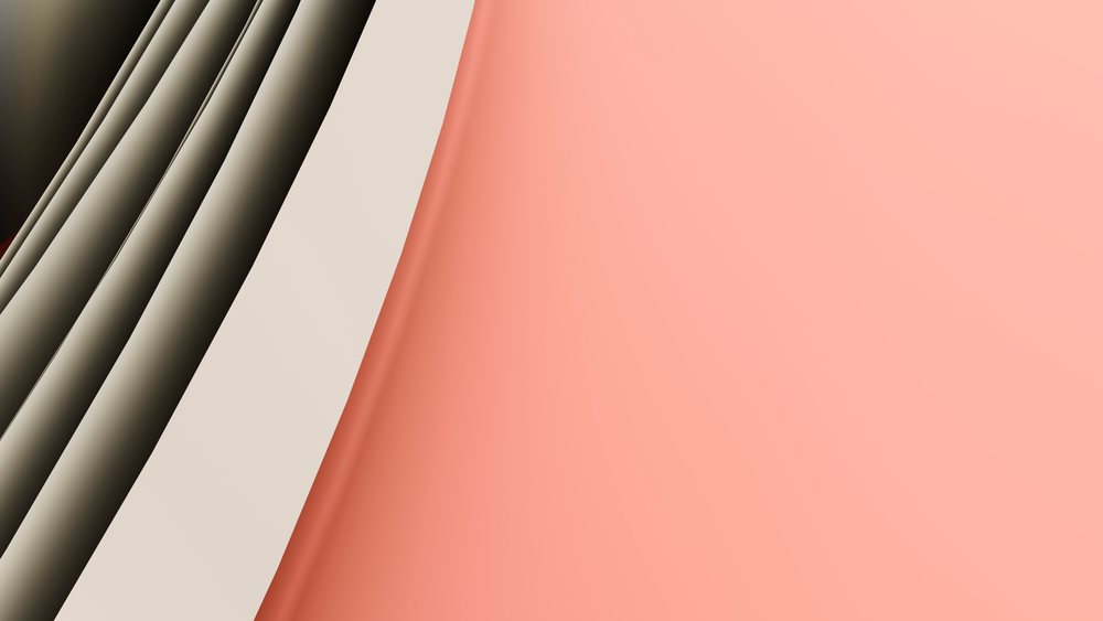 Folded stacked sheets of pink and cream paper with soft shadows creating an abstract background.