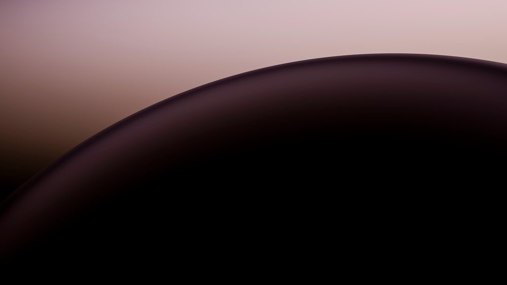 Close-up of a smooth, glossy black liquid curved surface with a subtle brownish gradient background.