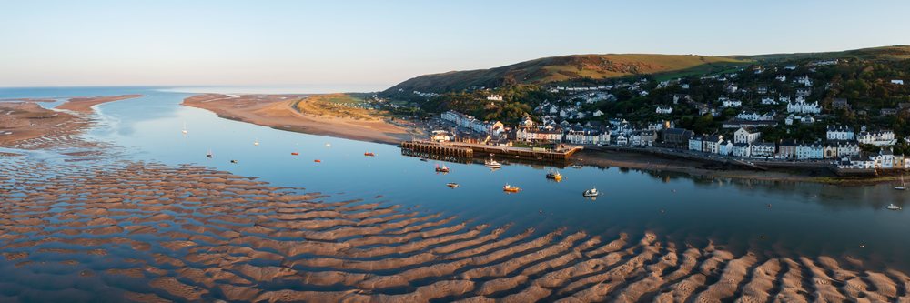Dolgellau town and harbor at Sunrise with boats on calm water and sandbanks near Ynyslas, Landscape, Aberdyfi, Gwynedd, Wales.