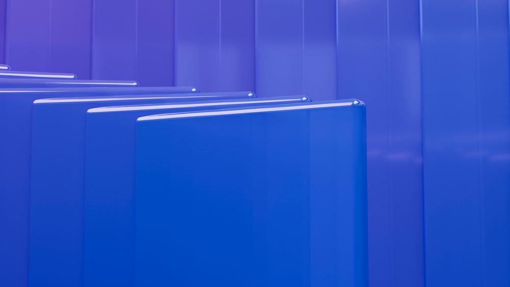 Blue abstract panels with smooth, shiny, reflective surfaces form a modern digital 3D geometric composition.