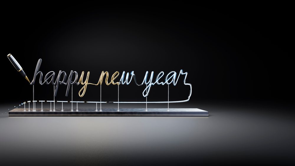 Neon tubing spelling happy new year held by a pen mounted on a metal base against a black background.