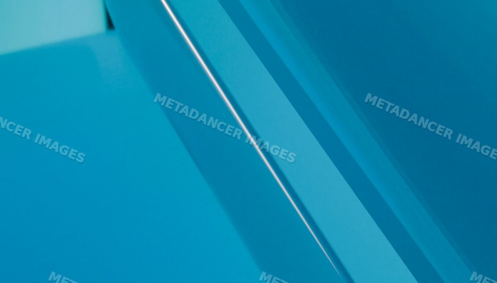 Close-up of layered blue glass showing abstract geometric reflections