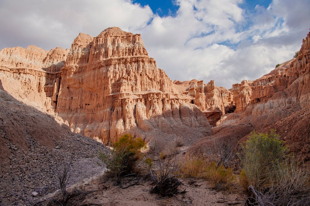 Red sandstone rock formations and cliffs, under a partly cloudy sky, national park, Cathedral Gorge State Park, Nevada, USA.