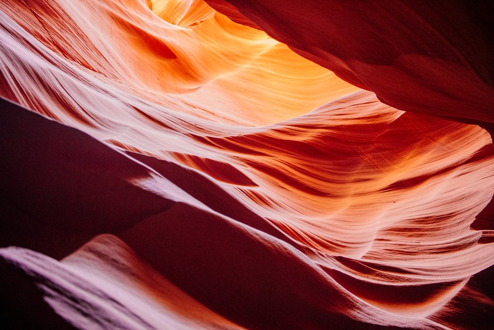 Curved sandstone rock formations in Antelope Canyon showing slot canyon textures and light patterns, Navajo Land, Arizona, USA.