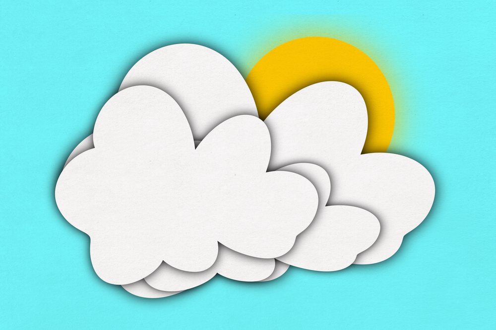 White layered paper cutout clouds partially covering the yellow sun against a bright blue background in an illustration.