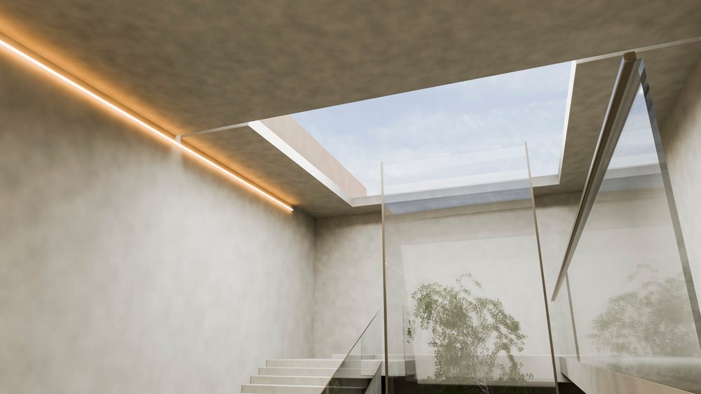 Modern indoor staircase with glass railing.