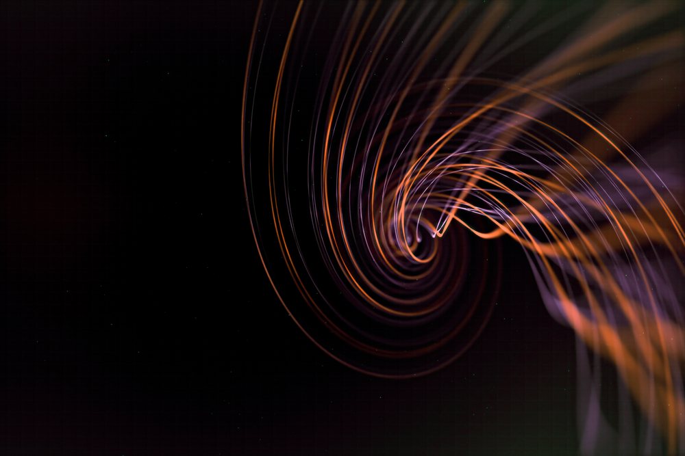An abstract swirl of orange and purple light trails on a dark background creating a vibrant spiral effect.