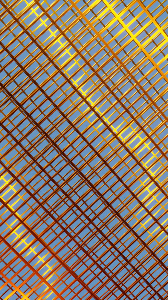 metallic gold grid structure with intersecting lines set against a clear blue sky.