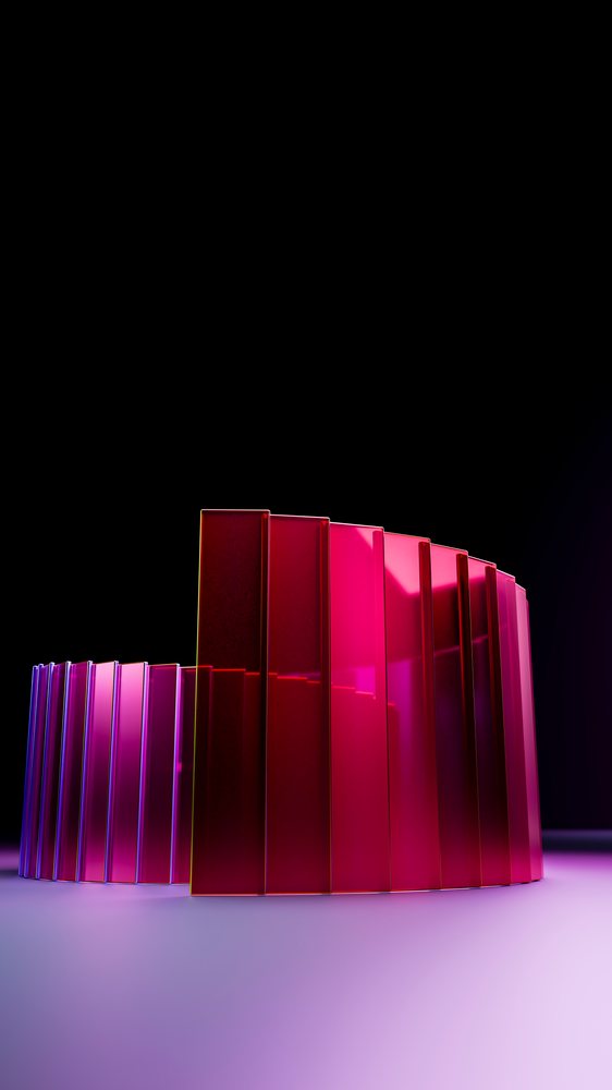 Abstract geometric sculpture with colorful curved panels illuminated in pink and purple on a minimalist surface.