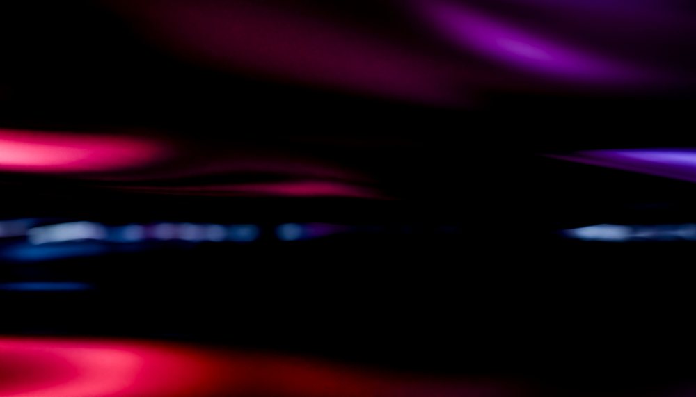 Abstract colorful waves with smooth blurred lights and shadow creating a dynamic gradient pattern.