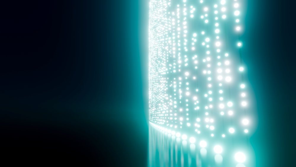 LED wall emits glowing blue light dots in an abstract digital pattern against a dark background.
