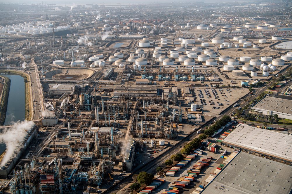 Oil refinery and fuel storage tanks at the Port of Long Beach, California, featuring an industrial plant with shipping containers and related infrastructure, CA, USA.