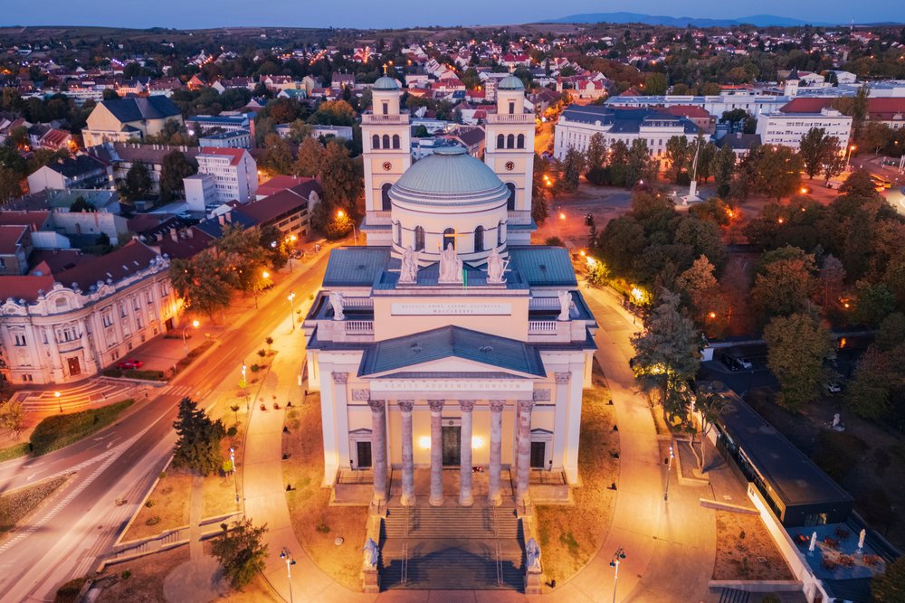 Cathedral Basilica of St John the Apostle illuminated at dusk in Eger cityscape, Hungary.