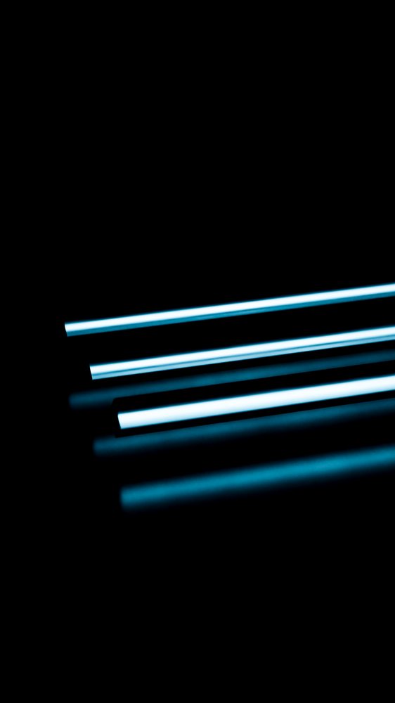 Blue neon light tubes arranged horizontally on a dark background with their reflections visible below.