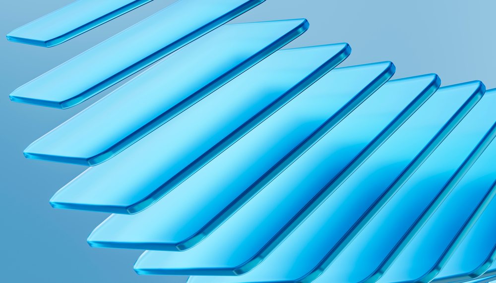 Transparent blue glass panels layered diagonally creating an abstract modern design.