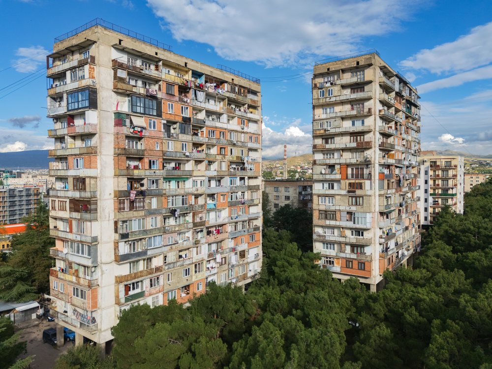 Two late Soviet-era residential apartment buildings with balconies and laundry hanging, Cityscapes, Tbilisi, Georgia.