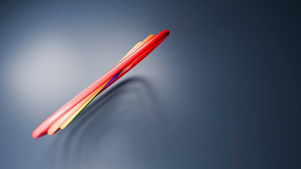 Intertwined colorful curved tubes with glossy surfaces against a smooth blue background in a 3D digital rendering.
