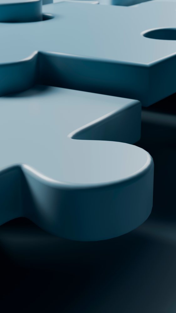 Close-up illustration of interlocking blue puzzle pieces representing connection and teamwork.