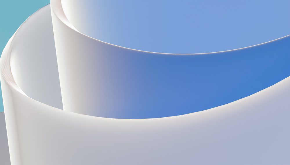 Abstract digital render showing smooth white curved shapes on a blue background with minimalist design.
