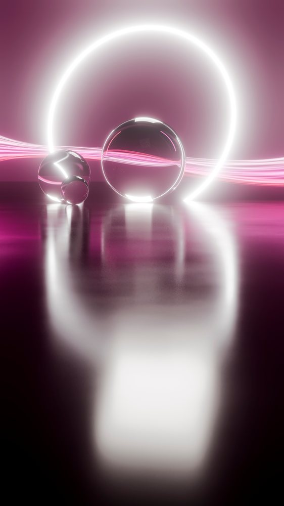 Three transparent glass spheres placed on a reflective surface.