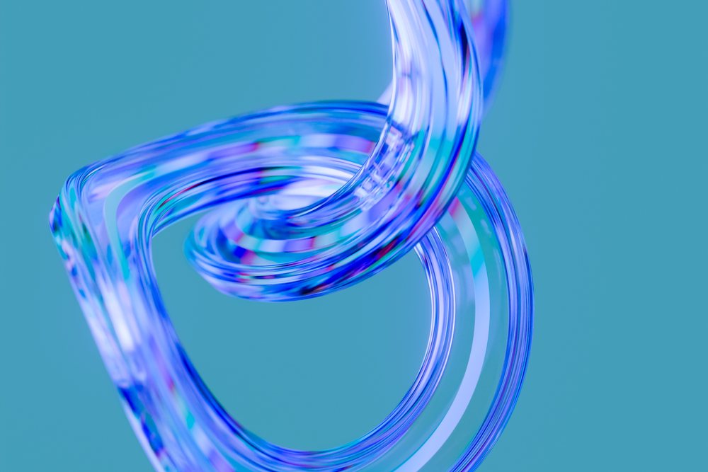 Abstract transparent glass loop with colorful light reflections on a blue background.