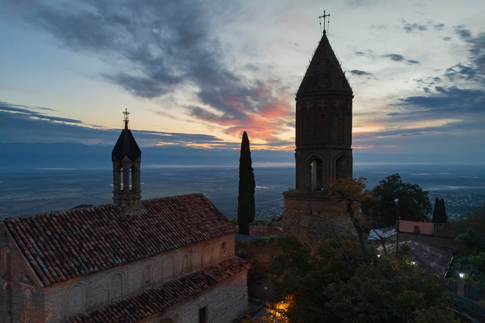St George's Church with bell tower at sunset on a hilltop overlooking the valley, Skylines, Sighnaghi, Georgia.