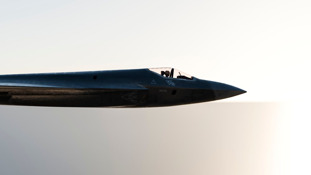 Profile view of a military stealth fighter jet showing cockpit and nose against a plain background, defense, war, security.