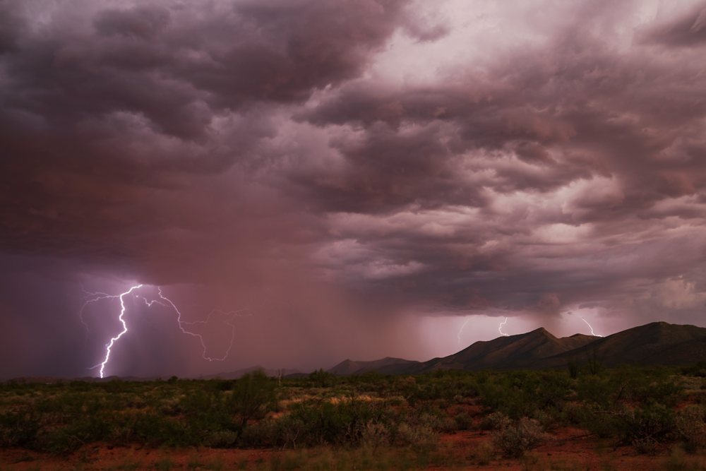 Lightning strikes over a stormy desert landscape with mountains and vegetation, Storm Chasing, Weather, Environmental Issues, Sierra Vista, Arizona, USA.
