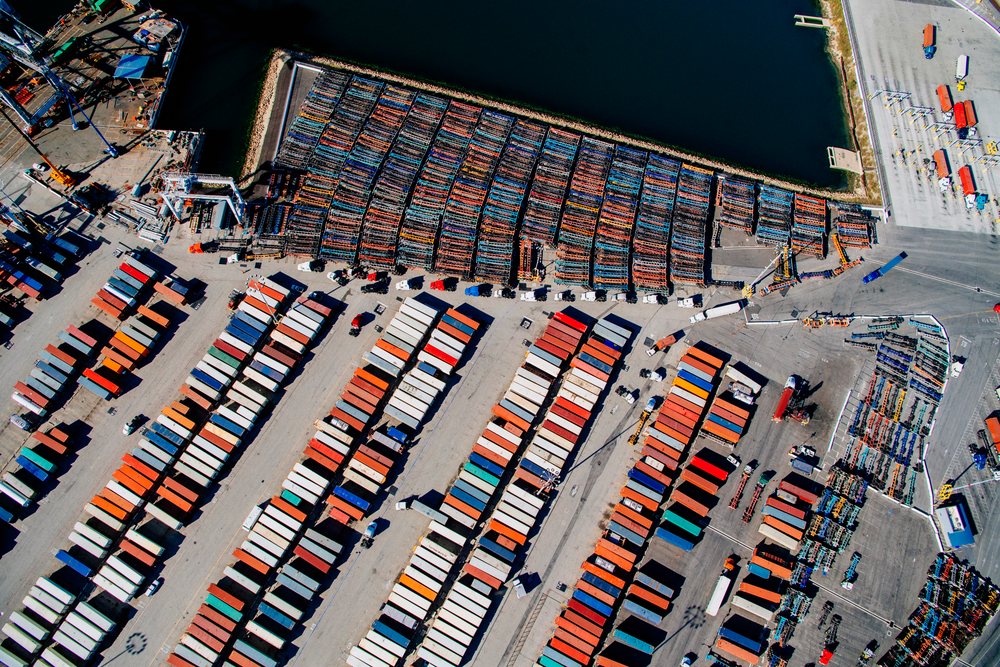 Aerial view of shipping containers and trucks in the container yard at the port in Long Beach, port in Long Beach, CA, USA.