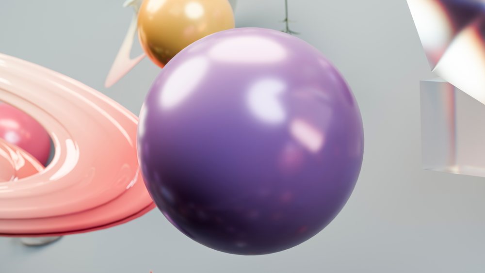 Glossy purple and yellow spheres float with pink rings and translucent geometric shapes in an abstract composition.