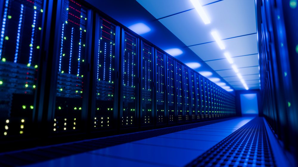 Data center hallway is lined with multiple server racks.
