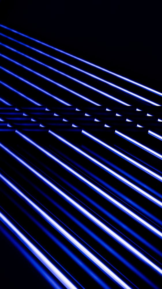 Blue glowing parallel light streaks form an abstract pattern on a dark background.