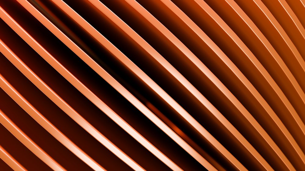 Orange curved metal stripes form an abstract pattern with reflective smooth surfaces and parallel lines.