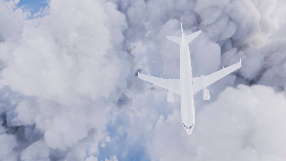Airplane flying above dense clouds in the sky captured from an aerial viewpoint.