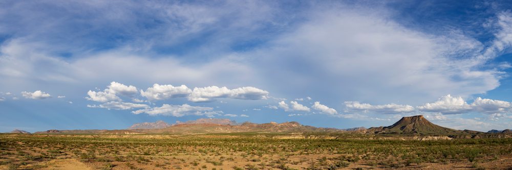 Clouds drift over the rocky Chisos Mountains amid the arid desert landscape of, Big Bend National Park, Texas, USA.