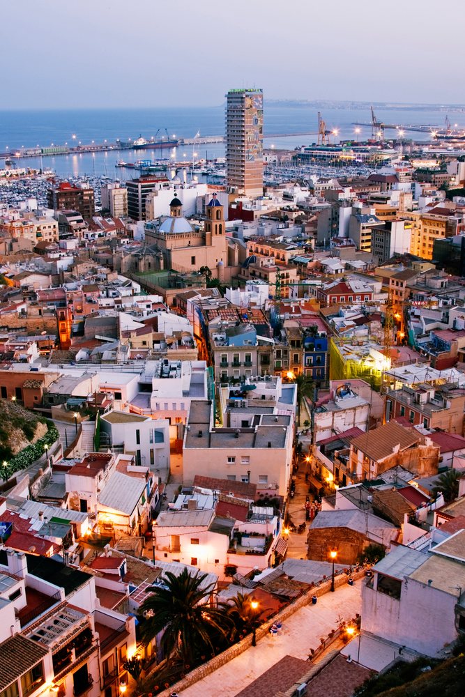 Cityscape with harbor and buildings at dusk, Costa Blanca, Spain.