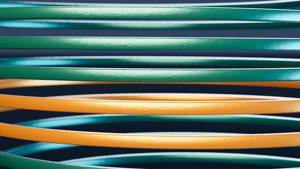 Close-up of colorful elastic bands arranged horizontally with visible rubber texture and overlapping in a studio setting.