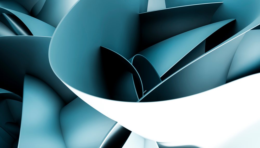 Curled and rolled blue paper forms abstract shapes in a studio close-up.