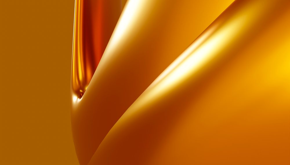 Close-up of a reflective metallic surface with smooth curved folds and bright highlights.