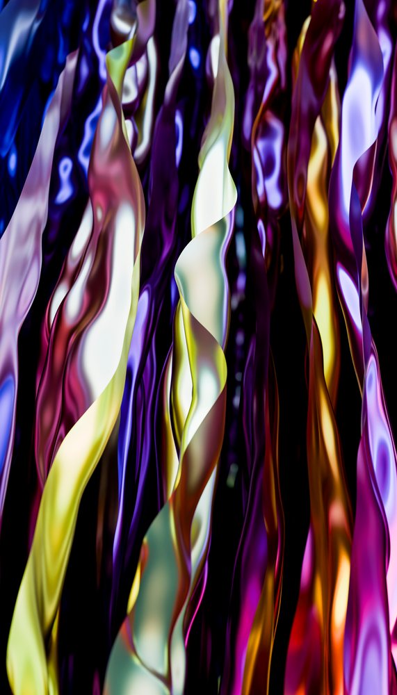 Colorful twisted glossy ribbons in various shades including purple, yellow, blue, and red creating an abstract decorative pattern.