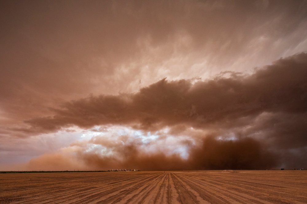 Dust Storm approaches with a severe supercell storm forming over a dry plowed field, Garden City, Texas, USA.