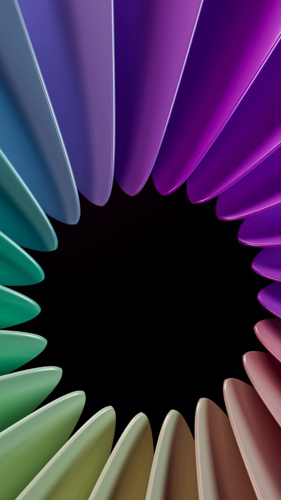 Close-up of multicolored plastic forks arranged in a symmetrical circular pattern on a black background.