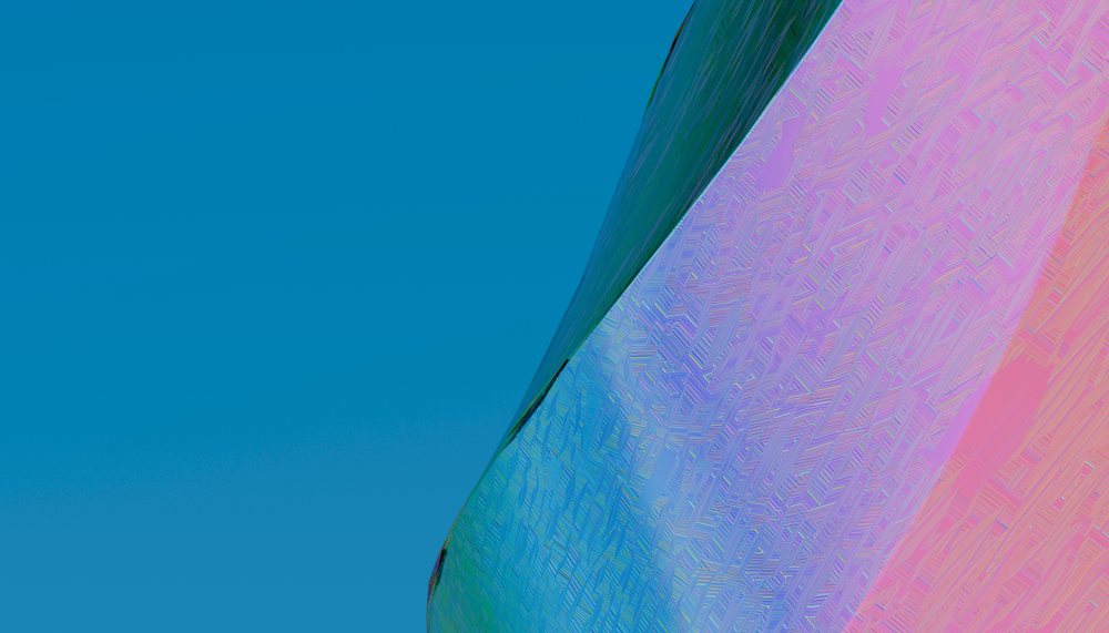Patterned colored glass panel with blue and pink hues against a clear blue sky.