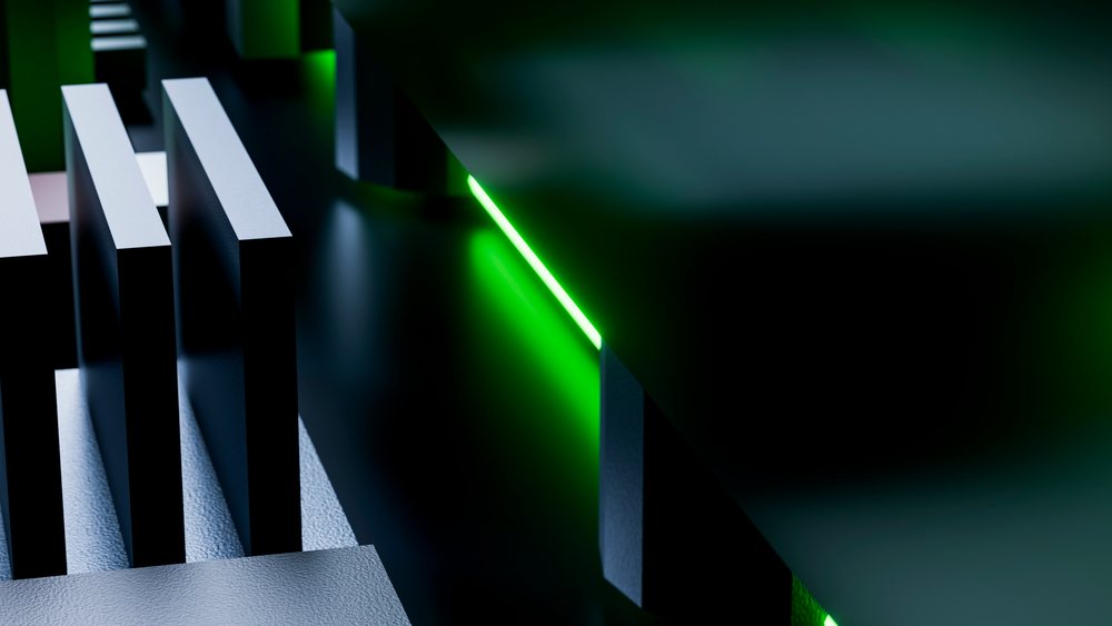 Abstract modern architectural structure featuring black and white geometric 3D shapes illuminated by green light.