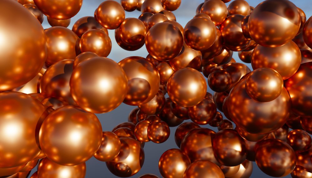 A cluster of shiny copper-colored metallic spheres floating against a neutral background.