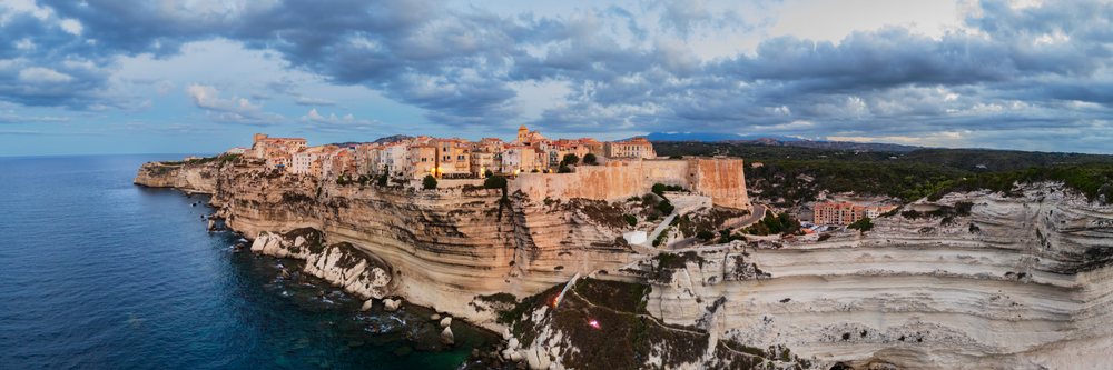 Citadel of Bonifacio perched on limestone cliffs overlooking the Mediterranean Sea at sunset, Travel Photography, Corsica, France.