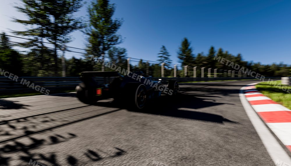 Black race car speeding around a curve on a racetrack