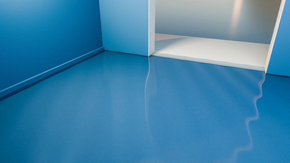 Blue shiny floor with white threshold at a doorway in a modern minimalist interior room transition.