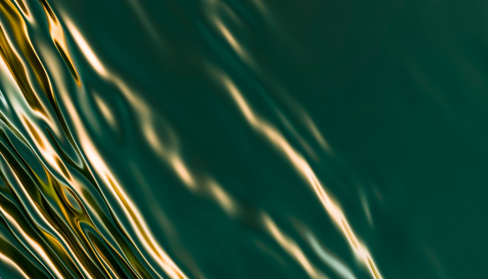 Water surface with light reflections creating fluid ripples and waves.